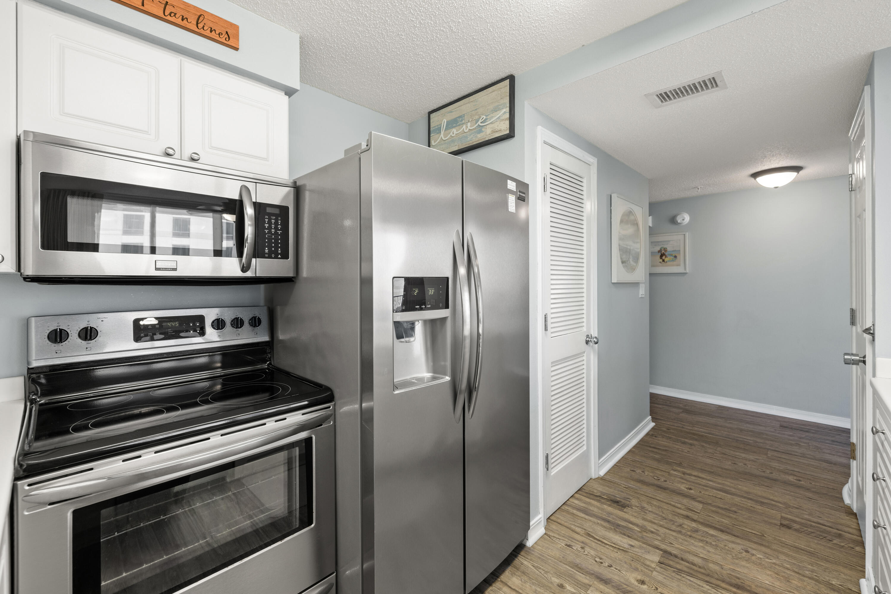 520 Santa Rosa Boulevard, Unit 319 Fort Walton Beach, FL 32548 - Photo 17 of 43 a kitchen with stainless steel appliances granite countertop a refrigerator and a stove