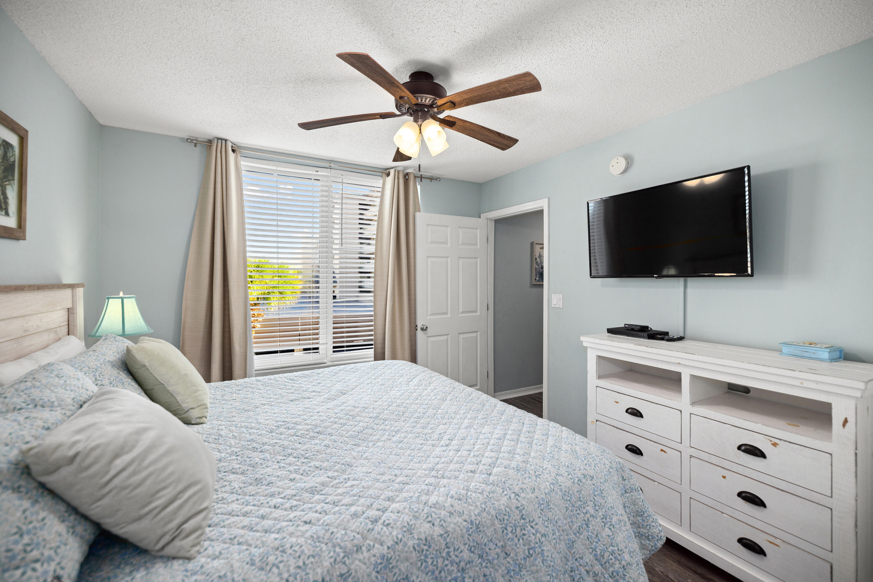 520 Santa Rosa Boulevard, Unit 319 Fort Walton Beach, FL 32548 - Photo 26 of 43 a bedroom with a large bed and a flat screen tv