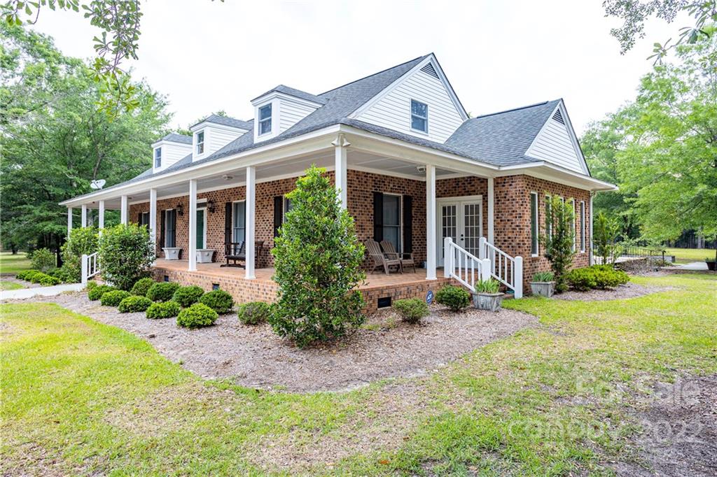 200 Hunt Trace, Unit B Camden, SC 29020 - Photo 27 of 40 a view of a house with backyard sitting area and garden
