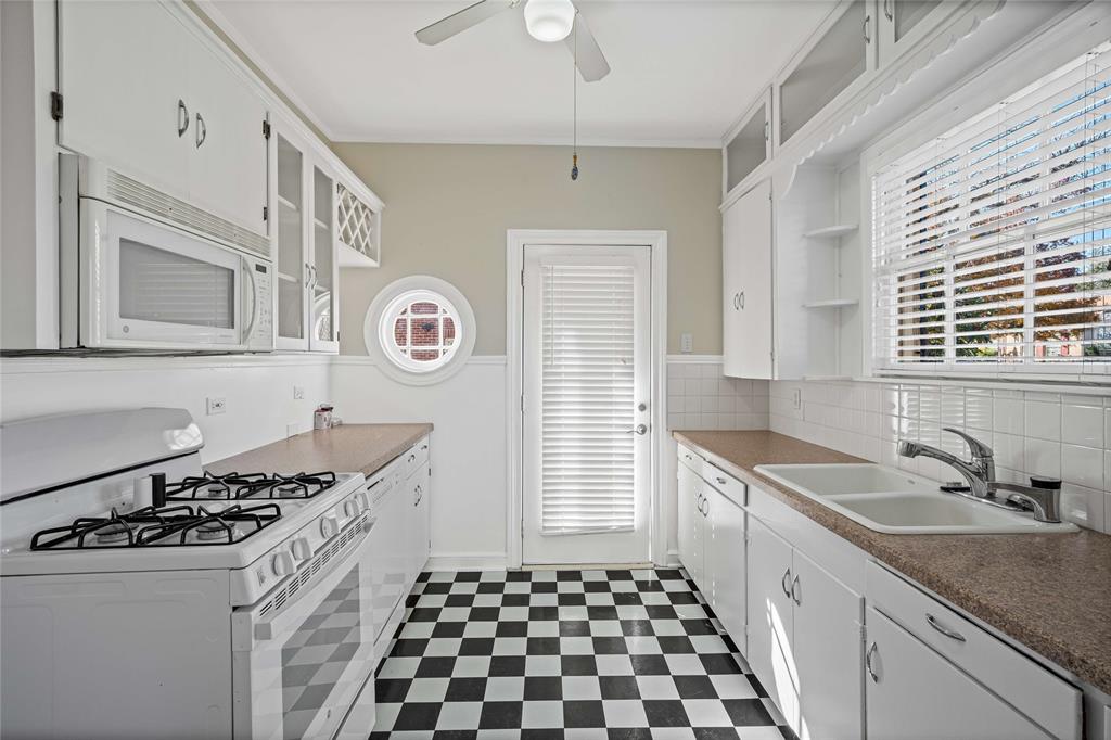 1919 North 7th Street Temple, TX 76501 - Photo 14 of 36 a kitchen with stainless steel appliances granite countertop a sink and a stove