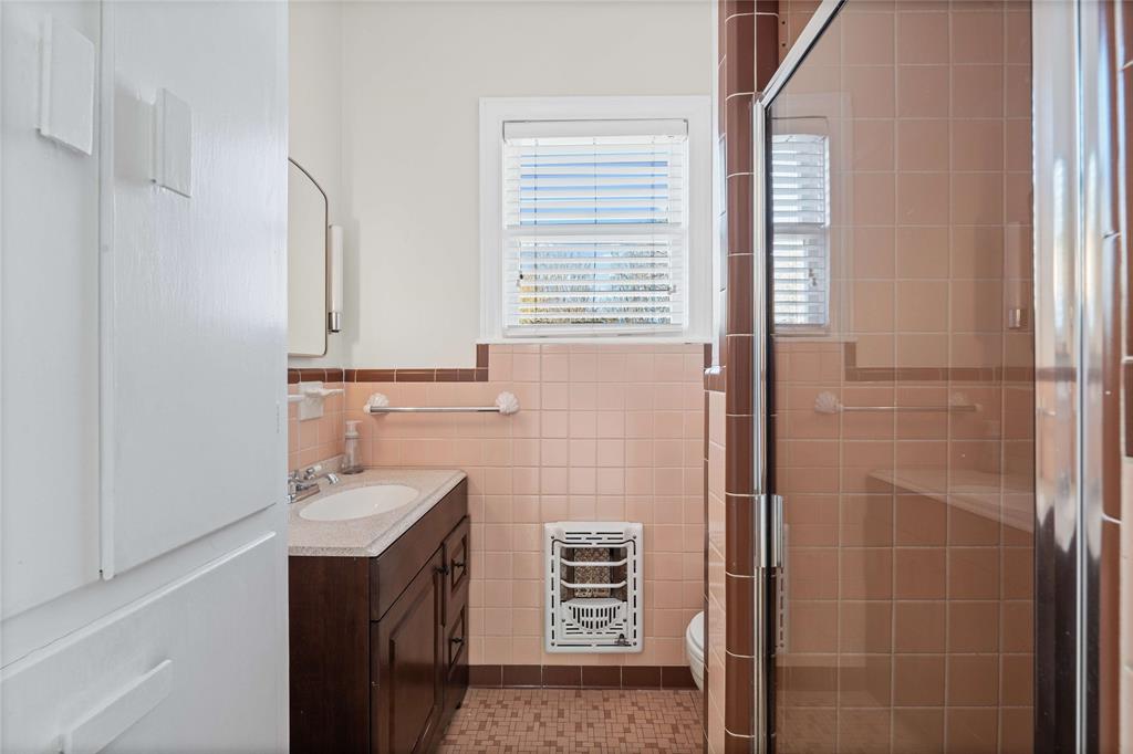 1919 North 7th Street Temple, TX 76501 - Photo 19 of 36 a bathroom with a sink a vanity and a mirror