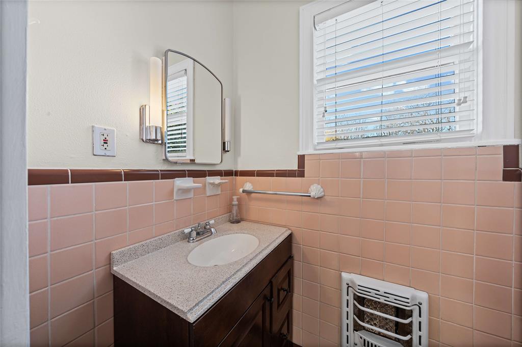 1919 North 7th Street Temple, TX 76501 - Photo 20 of 36 a bathroom with a sink a vanity and a mirror