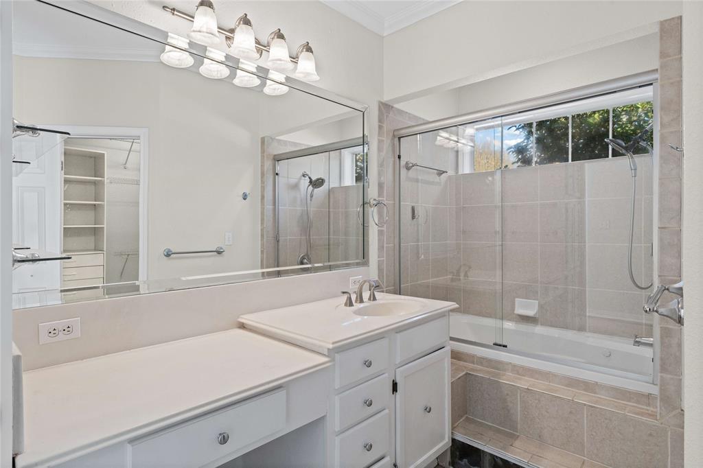 1919 North 7th Street Temple, TX 76501 - Photo 24 of 36 a bathroom with a tub a sink and mirror