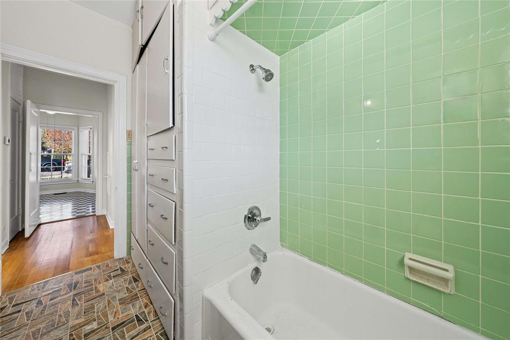 1919 North 7th Street Temple, TX 76501 - Photo 30 of 36 a bathroom with a bathtub and a shower