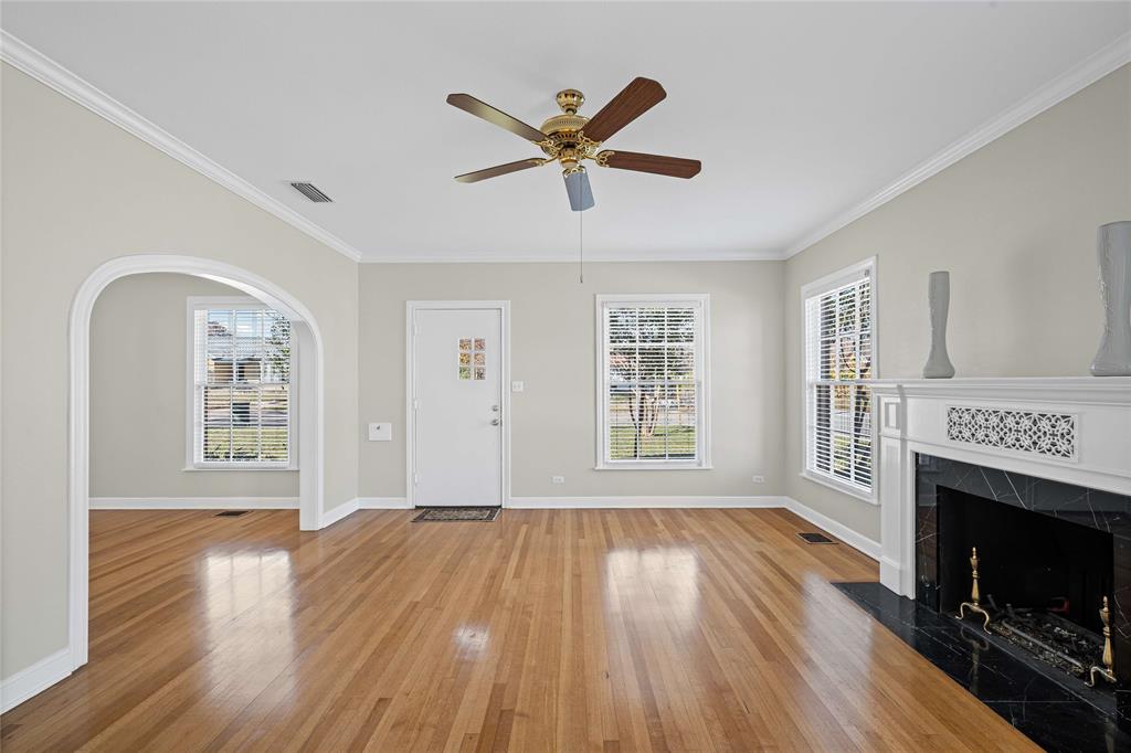 1919 North 7th Street Temple, TX 76501 - Photo 5 of 36 a view of a livingroom with a hardwood floor a ceiling fan and a window