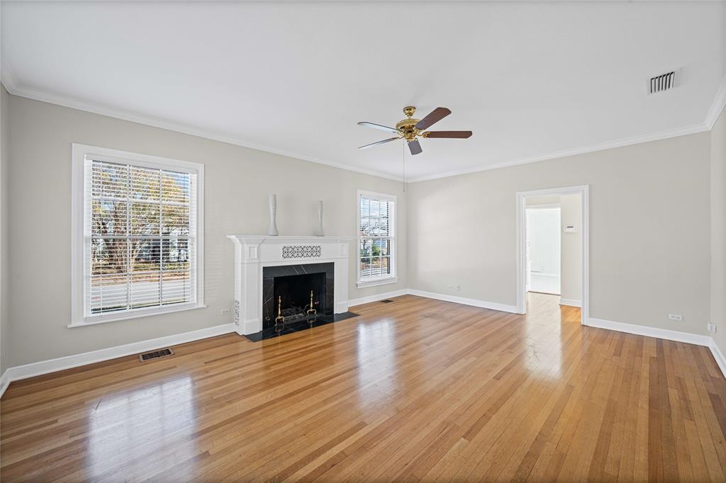 1919 North 7th Street Temple, TX 76501 - Photo 6 of 36 an empty room with windows fireplace and wooden floor