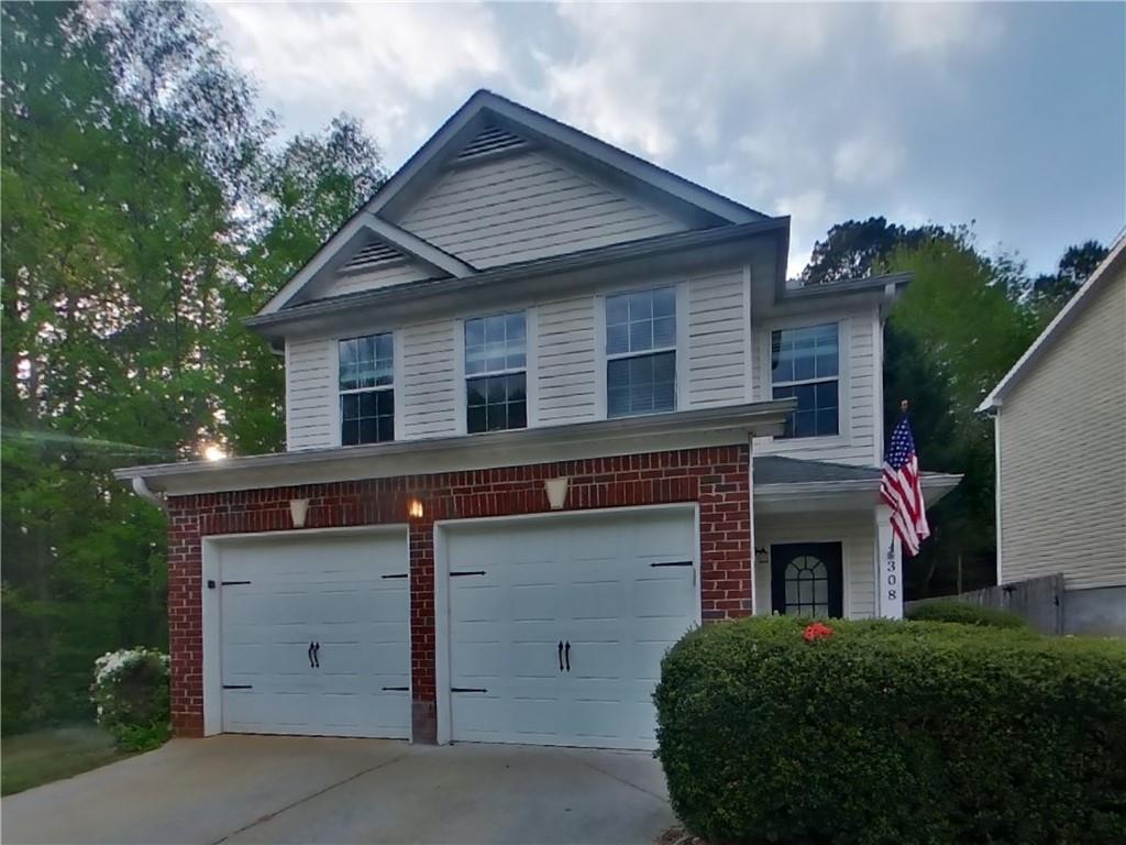 a front view of a house with garage