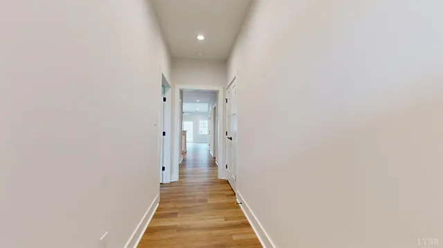 a view of a hallway with wooden floor