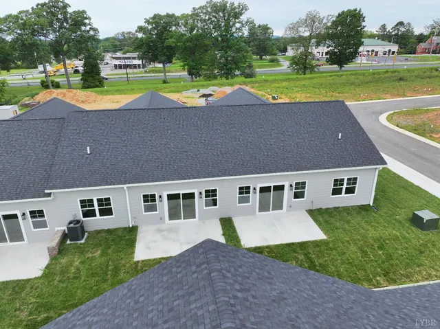 a aerial view of a house with a yard and a patio