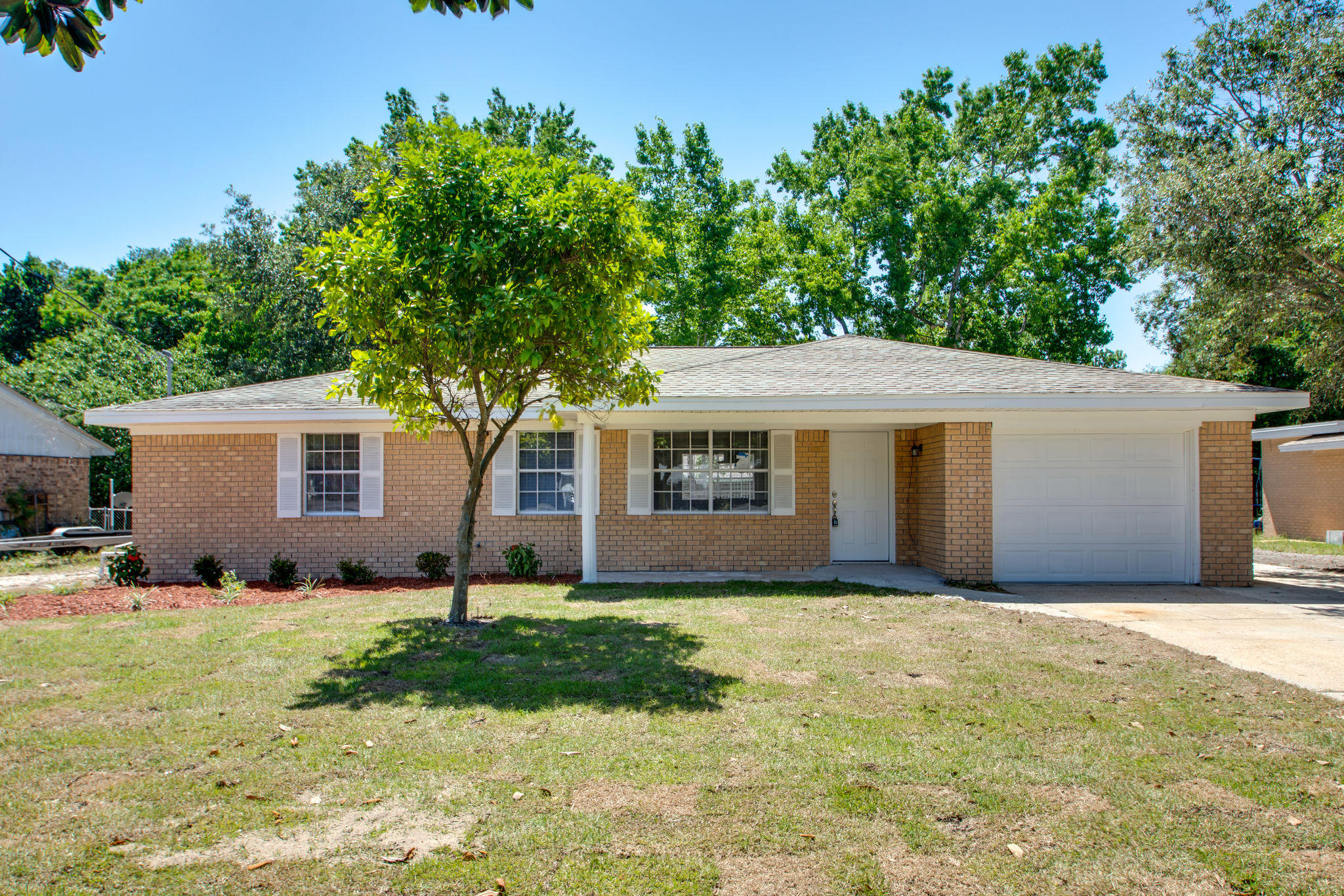 409 Main Street Destin, FL 32541 - Photo 1 of 19 a front view of a house with yard and trees