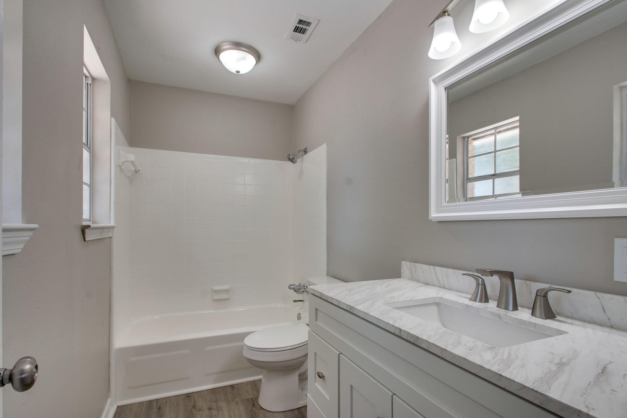 409 Main Street Destin, FL 32541 - Photo 12 of 19 a bathroom with a granite countertop sink a toilet and bathtub