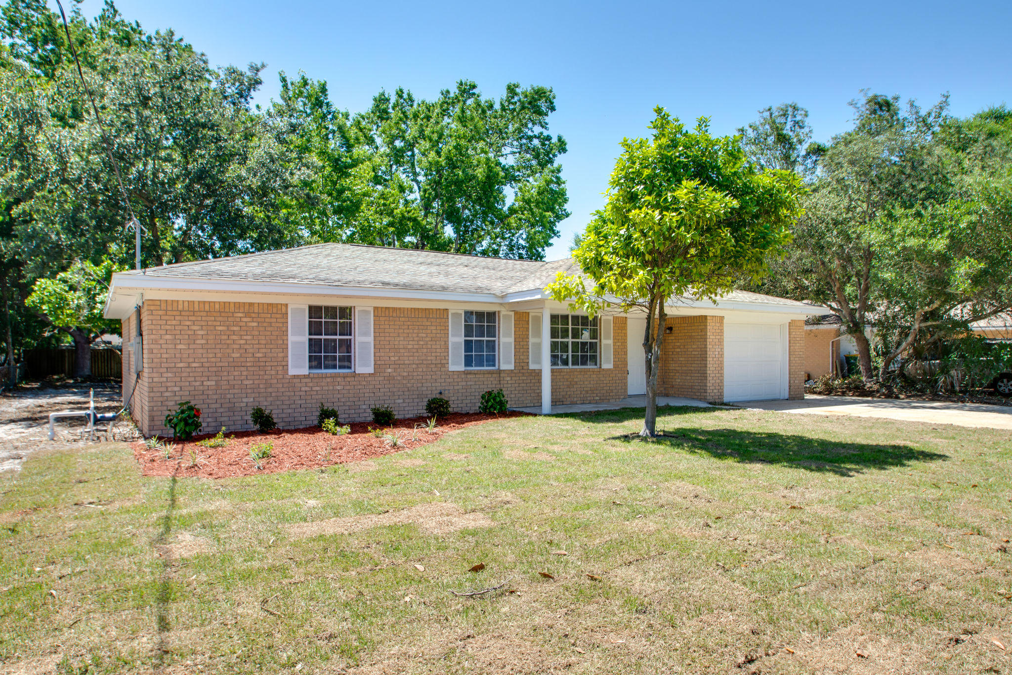 409 Main Street Destin, FL 32541 - Photo 3 of 19 a backyard of a house with yard and outdoor seating