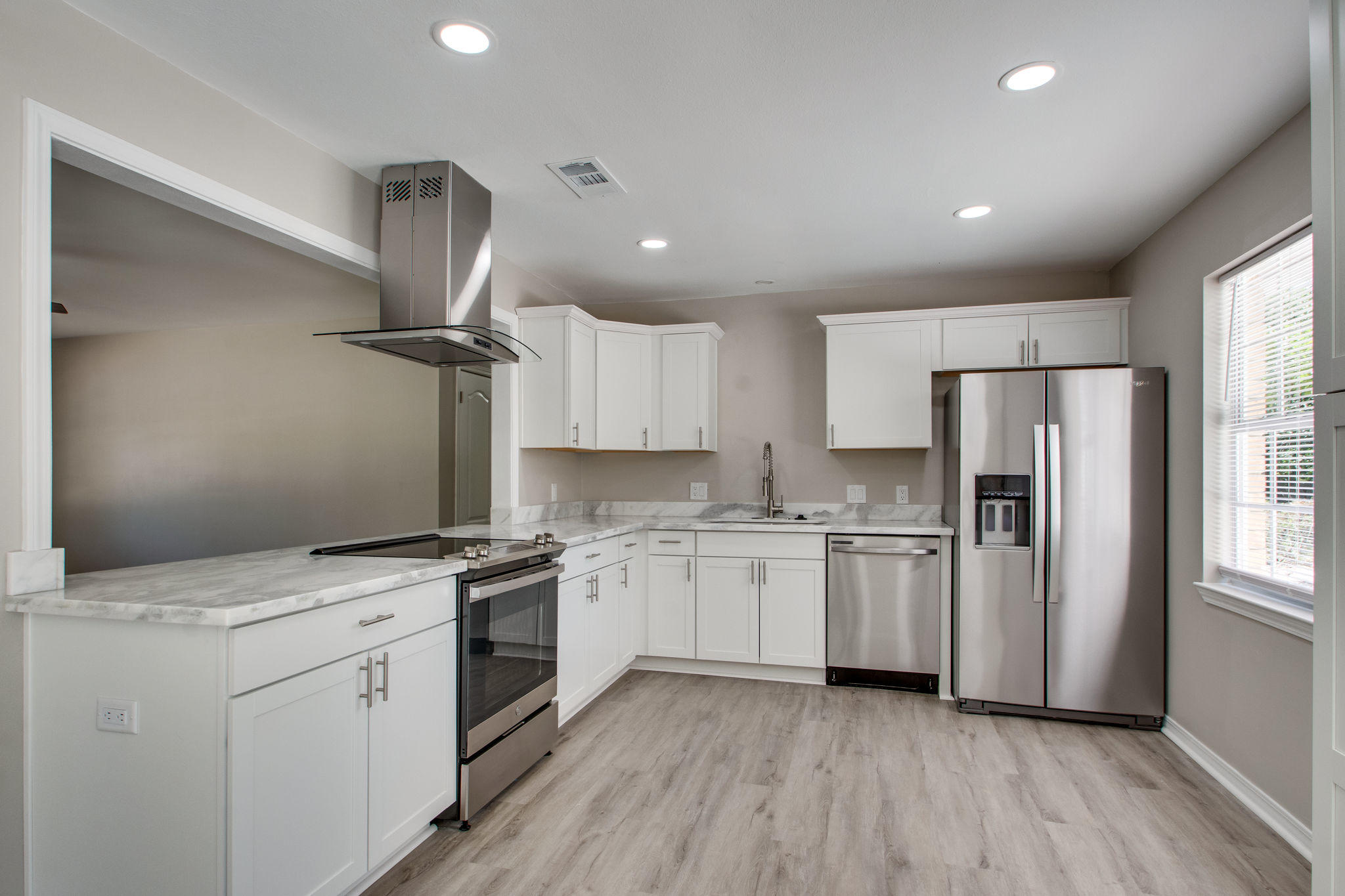 409 Main Street Destin, FL 32541 - Photo 4 of 19 a kitchen with white cabinets appliances and sink
