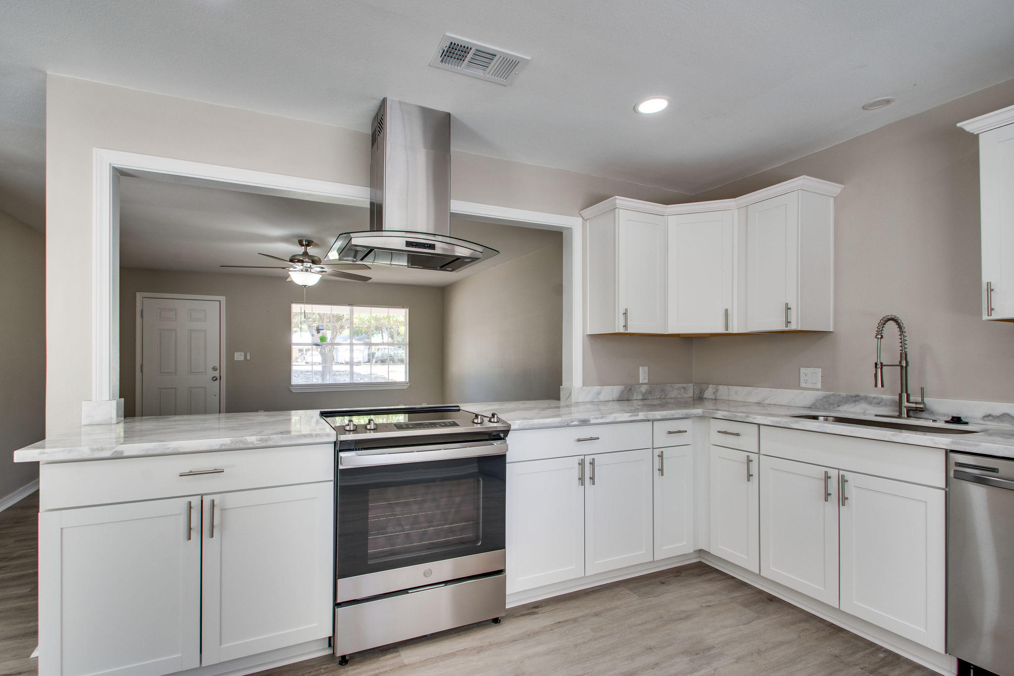 409 Main Street Destin, FL 32541 - Photo 5 of 19 a kitchen with a sink stove and cabinets