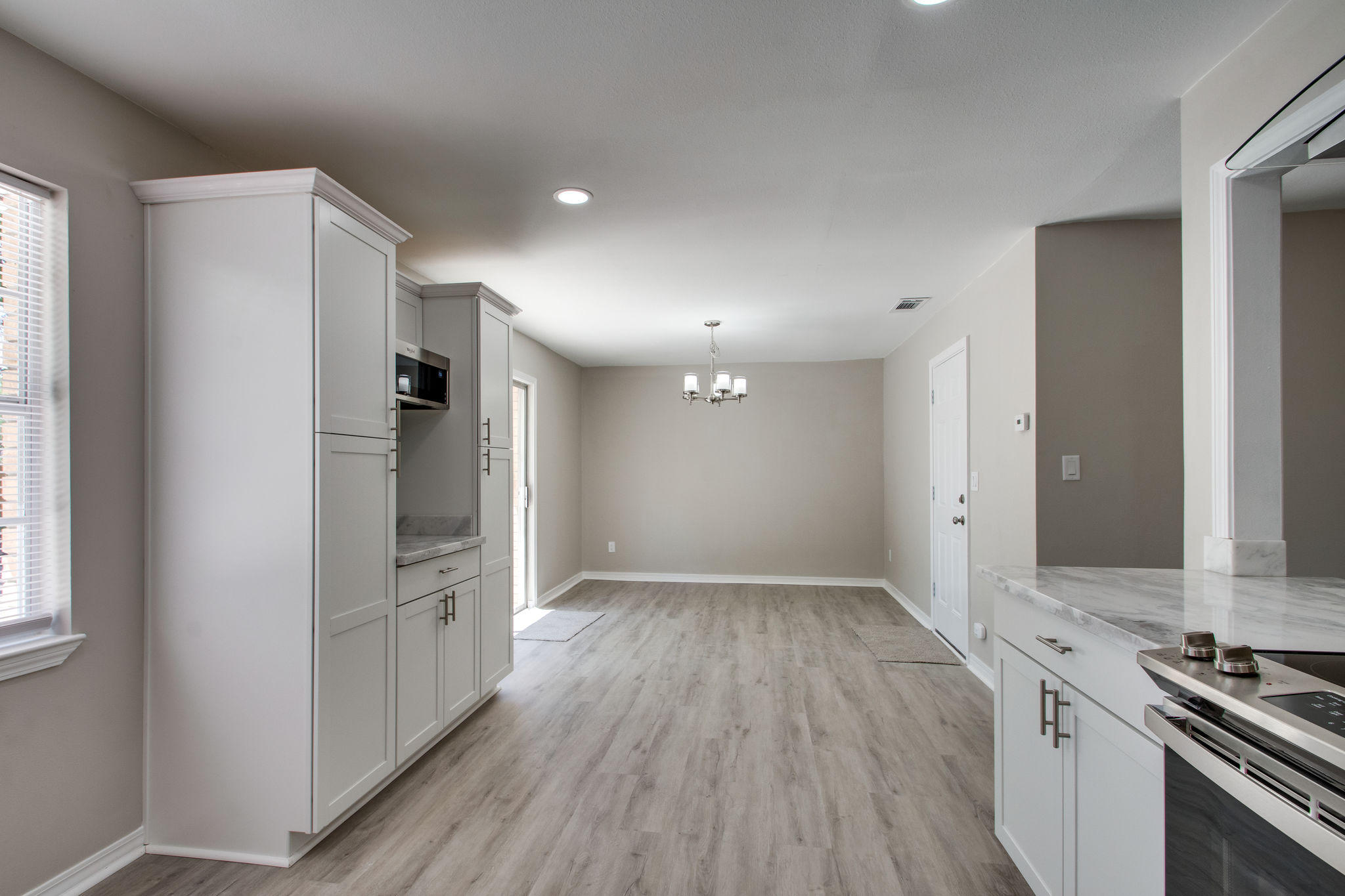 409 Main Street Destin, FL 32541 - Photo 6 of 19 an empty room with wooden floor and entrance