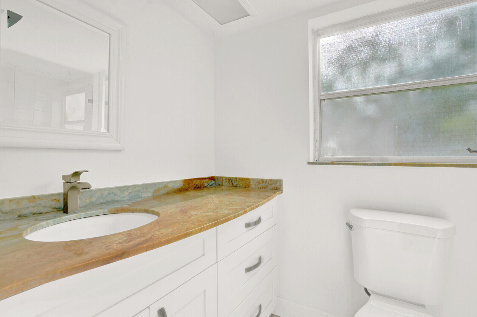 804 Cypress Boulevard, Unit 301 Pompano Beach, FL 33069 - Photo 19 of 34 a bathroom with a sink and a mirror