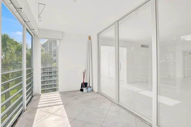 a view of a bathroom with a glass door shower and a sink