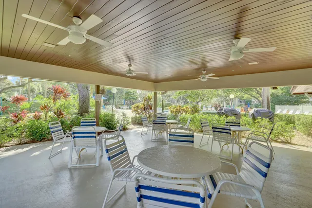 a dining room with furniture a rug and a large window