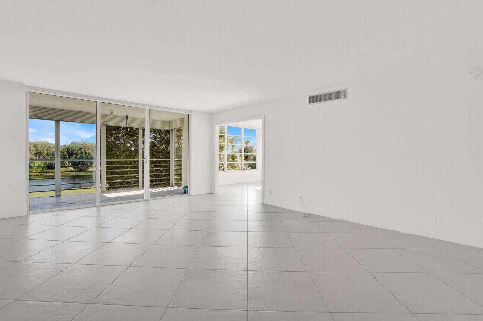 804 Cypress Boulevard, Unit 301 Pompano Beach, FL 33069 - Photo 6 of 34 a view of an empty room with a window
