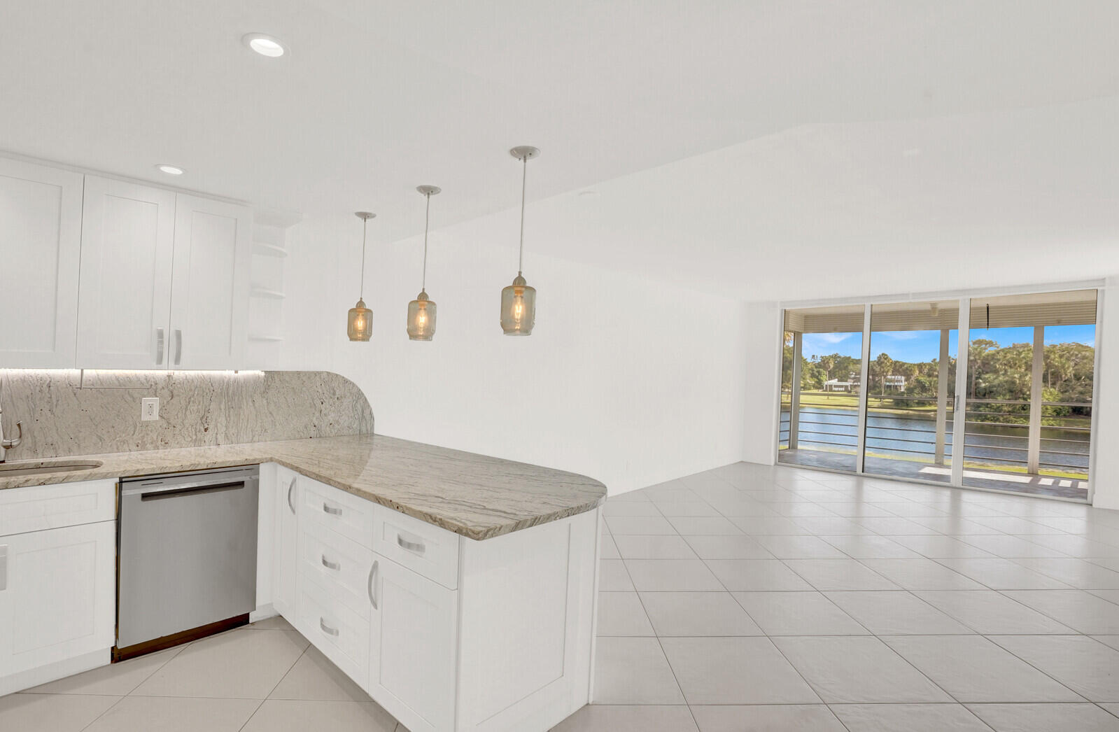804 Cypress Boulevard, Unit 301 Pompano Beach, FL 33069 - Photo 8 of 34 a kitchen with granite countertop a sink a stove and cabinets