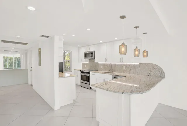 a spacious bathroom with a sink a mirror and a bathtub