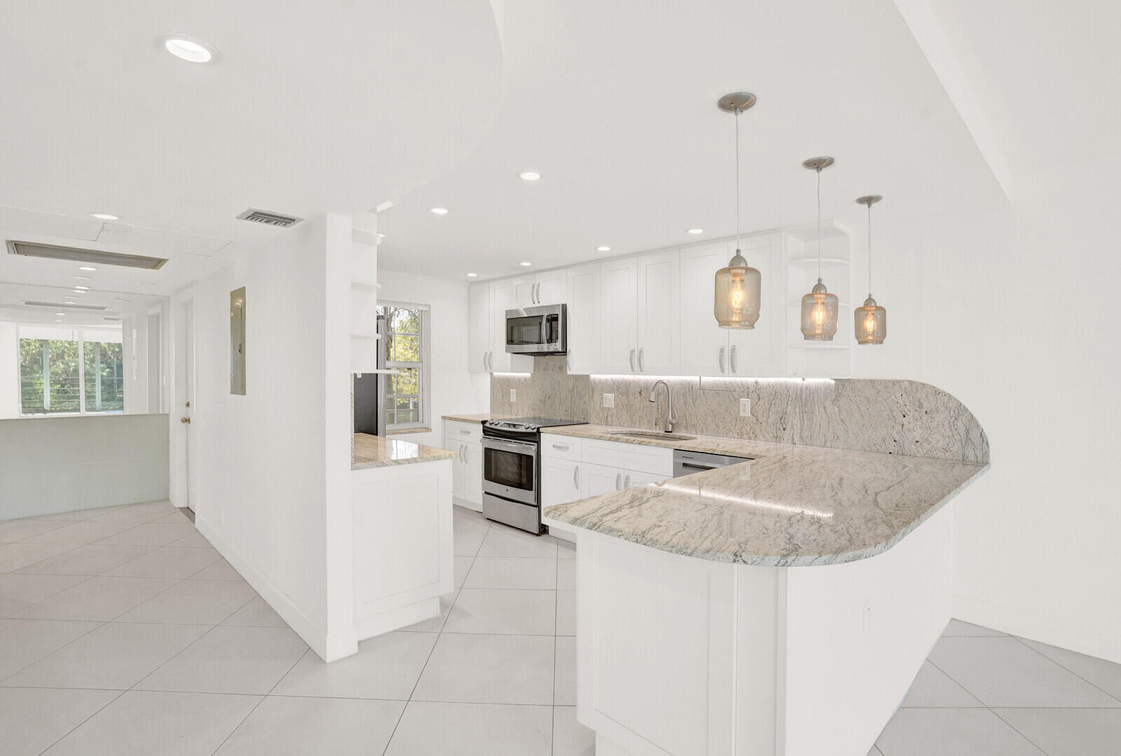 804 Cypress Boulevard, Unit 301 Pompano Beach, FL 33069 - Photo 9 of 34 a spacious bathroom with a sink a mirror and a bathtub