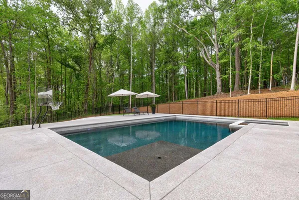 a view of a swimming pool with a backyard