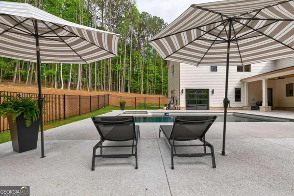 a view of a patio with table and chairs potted plants and palm tree