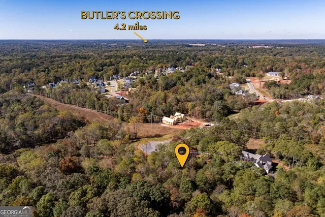 an aerial view of a house with a yard