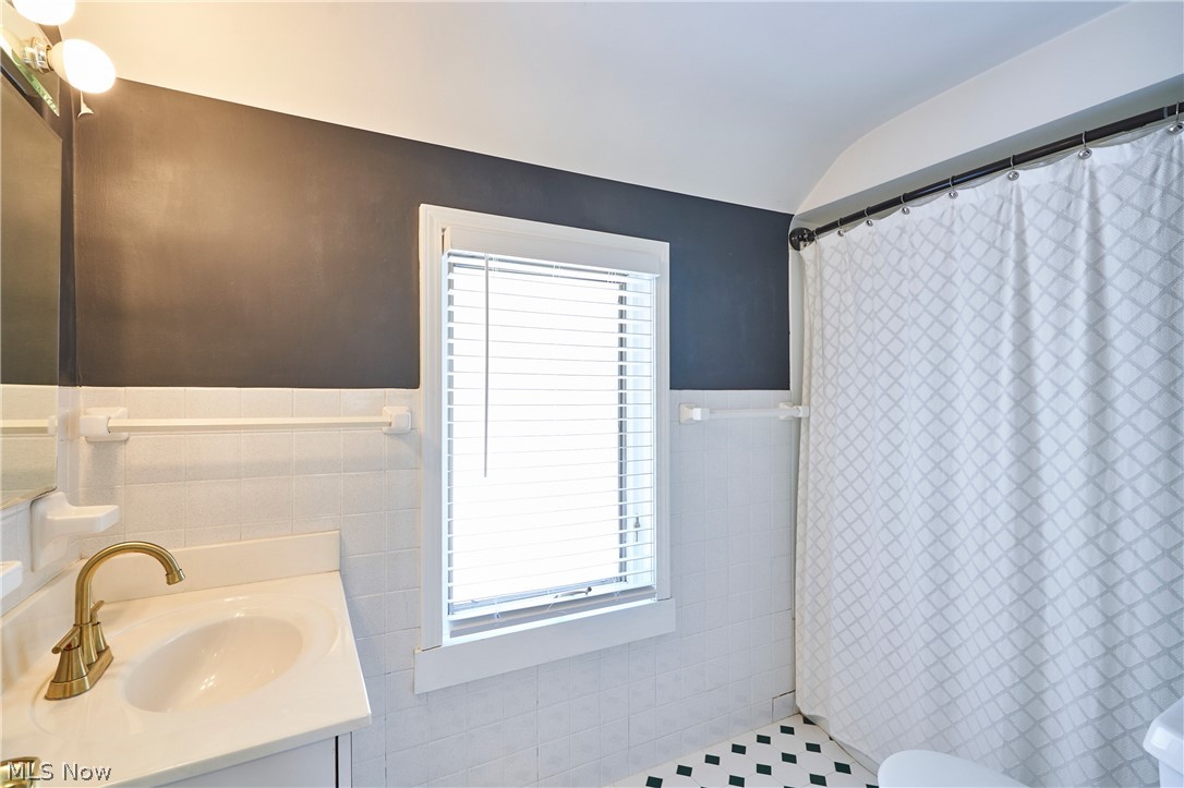 5215 Mayview Road Lyndhurst, OH 44124 - Photo 14 of 27 Remodeled bathroom with newer white cabinet and tiled floor