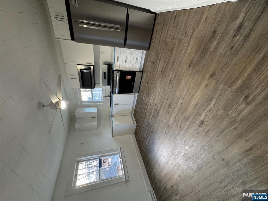 57 Old Hook Road, Unit 2 Westwood, NJ 07675 - Photo 2 of 13 a kitchen with granite countertop a refrigerator and a stove top oven
