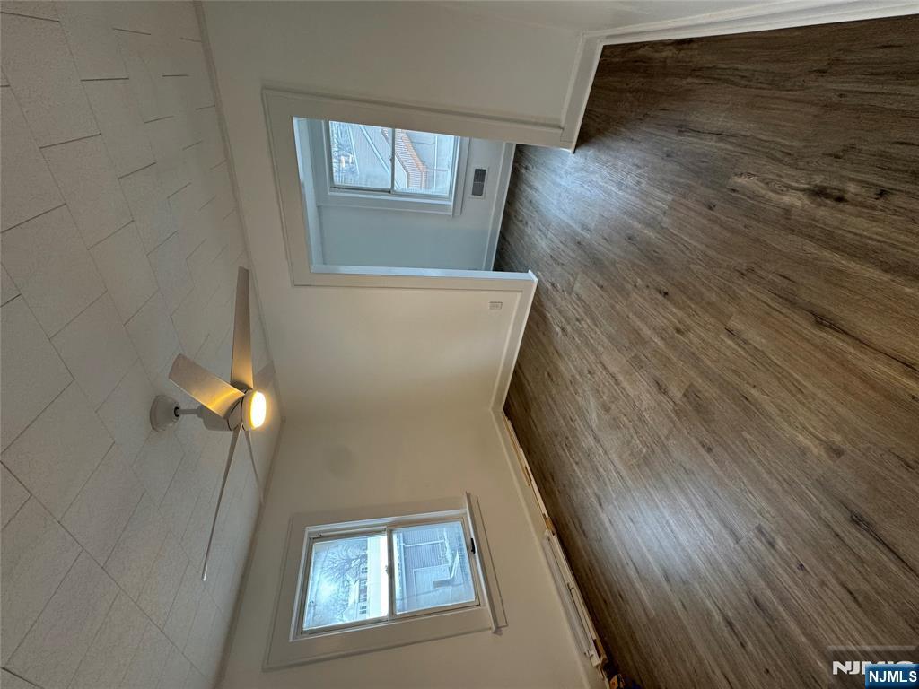 57 Old Hook Road, Unit 2 Westwood, NJ 07675 - Photo 5 of 13 an empty room with wooden floor and windows