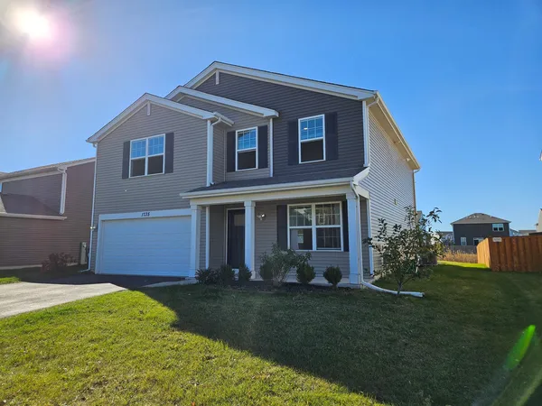 a front view of a house with a yard