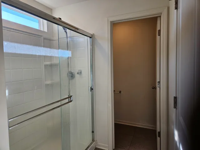 a bathroom with a glass shower door