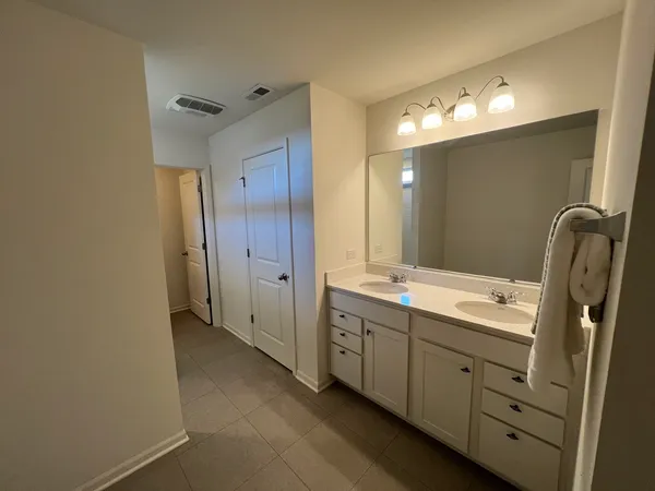 a bathroom with a double vanity sink mirror and double