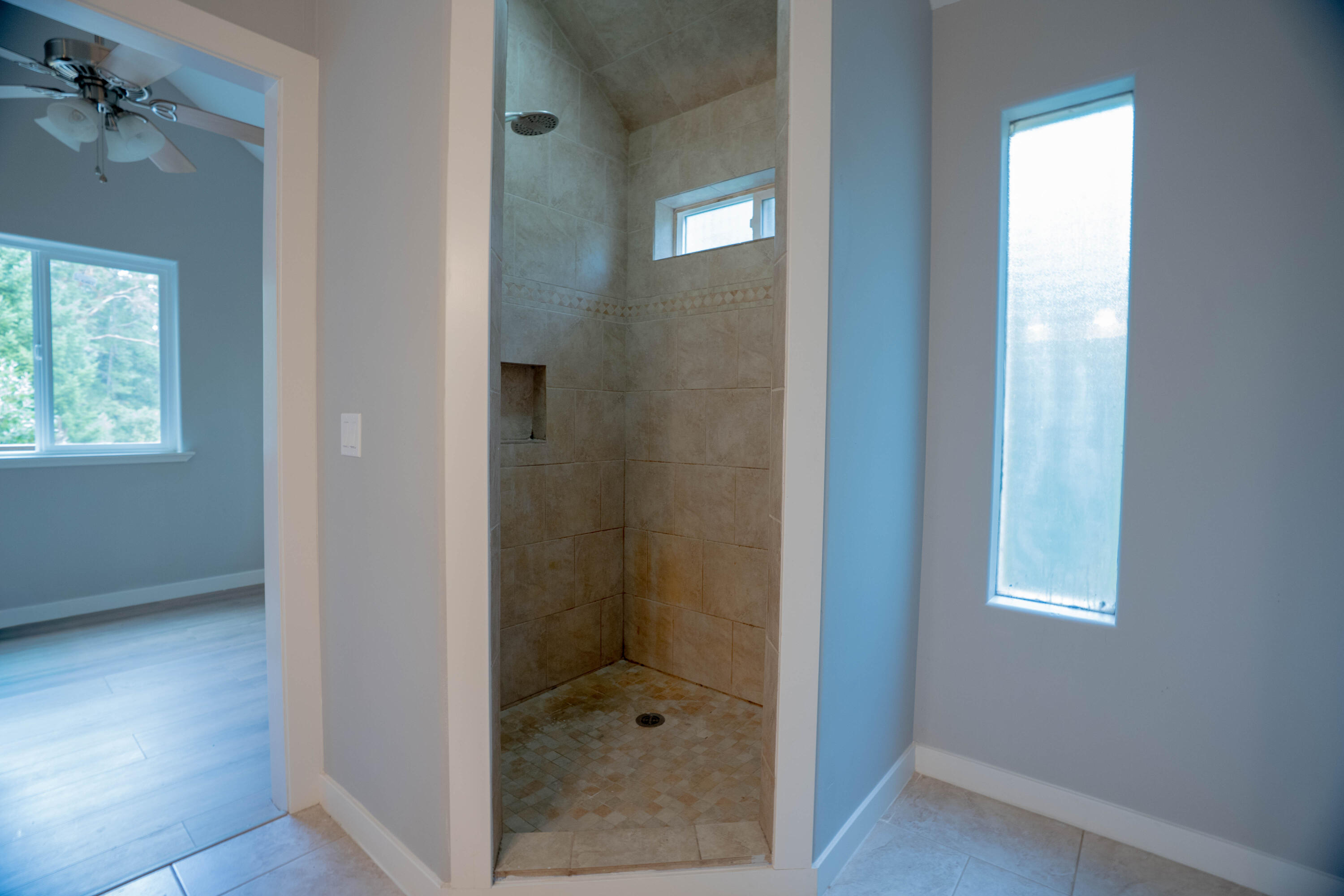 709 Pinewood Way Cave Junction, OR 97523 - Photo 14 of 24 a bathroom with a glass shower door and a window