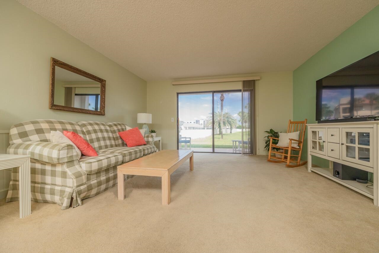21 Dondanville Road, Unit 2 St. Augustine, FL 32080 - Photo 13 of 40 a bedroom with furniture and a flat screen tv
