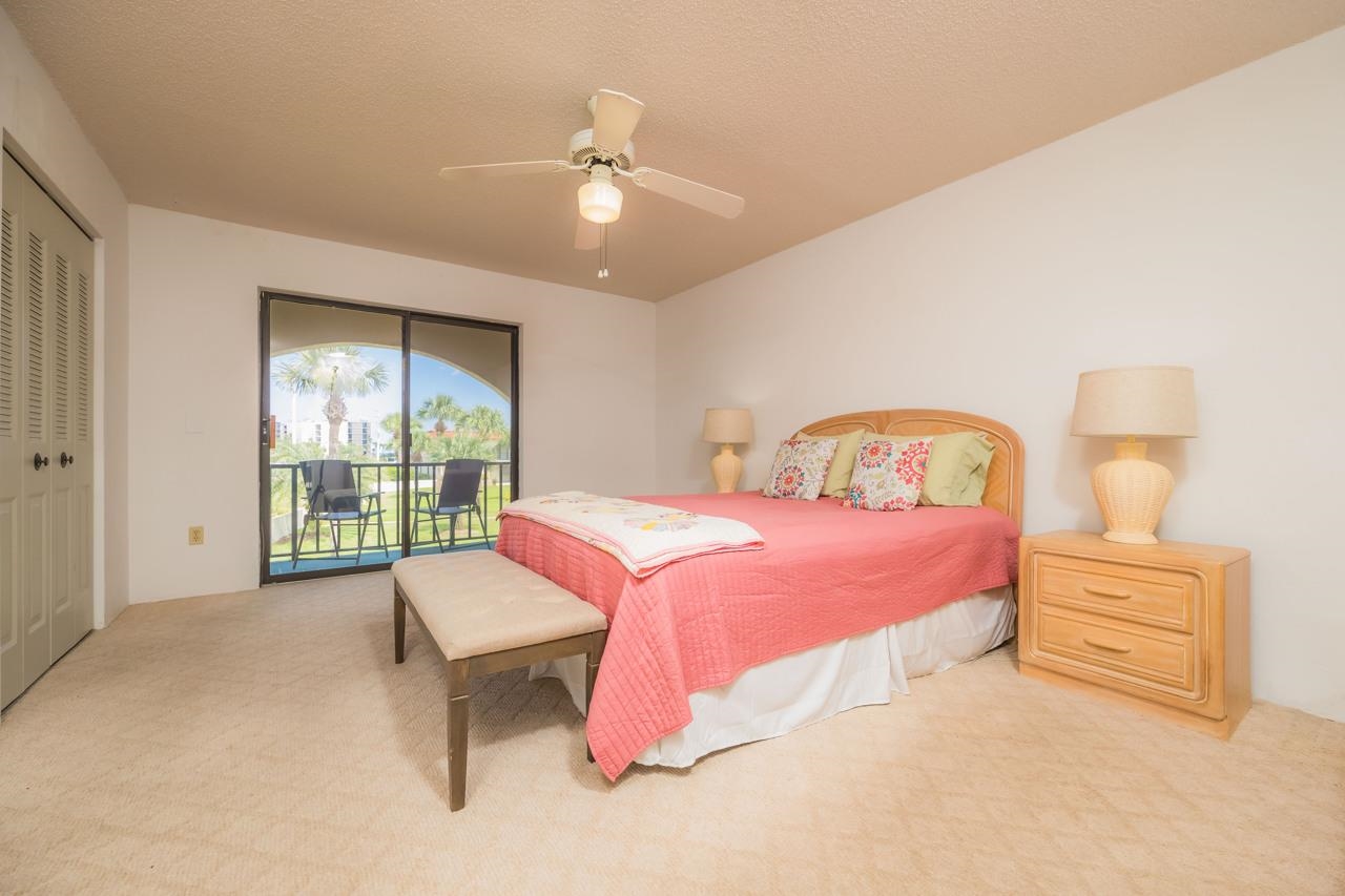 21 Dondanville Road, Unit 2 St. Augustine, FL 32080 - Photo 20 of 40 a bedroom with a bed and a chandelier