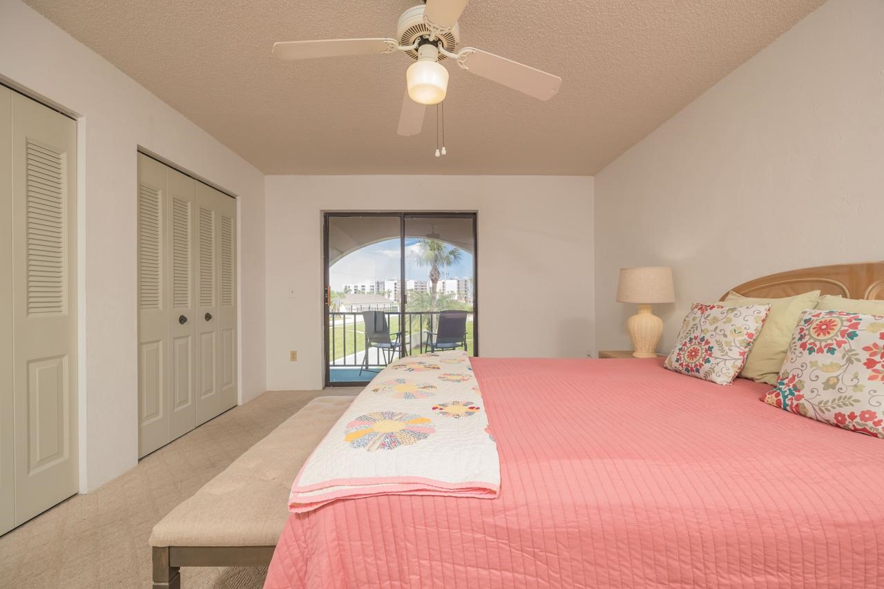 21 Dondanville Road, Unit 2 St. Augustine, FL 32080 - Photo 21 of 40 a bedroom with a large bed and a chandelier