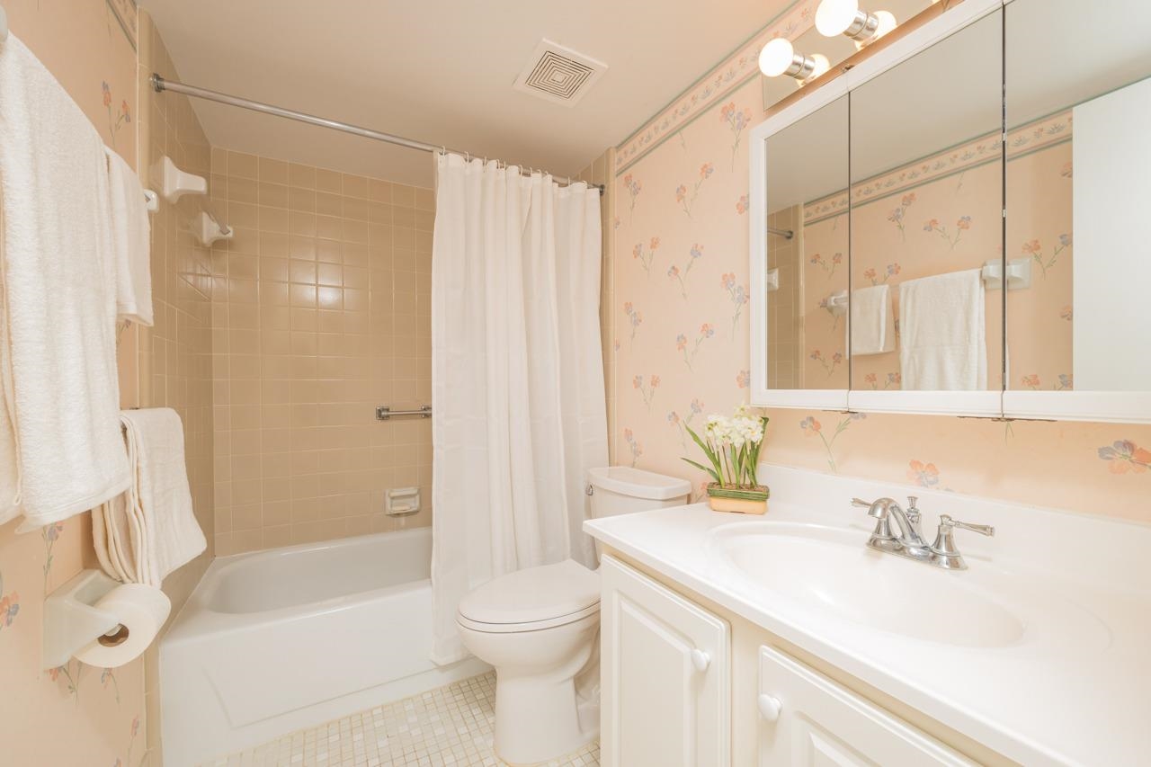 21 Dondanville Road, Unit 2 St. Augustine, FL 32080 - Photo 24 of 40 a bathroom with a sink a toilet a mirror and shower