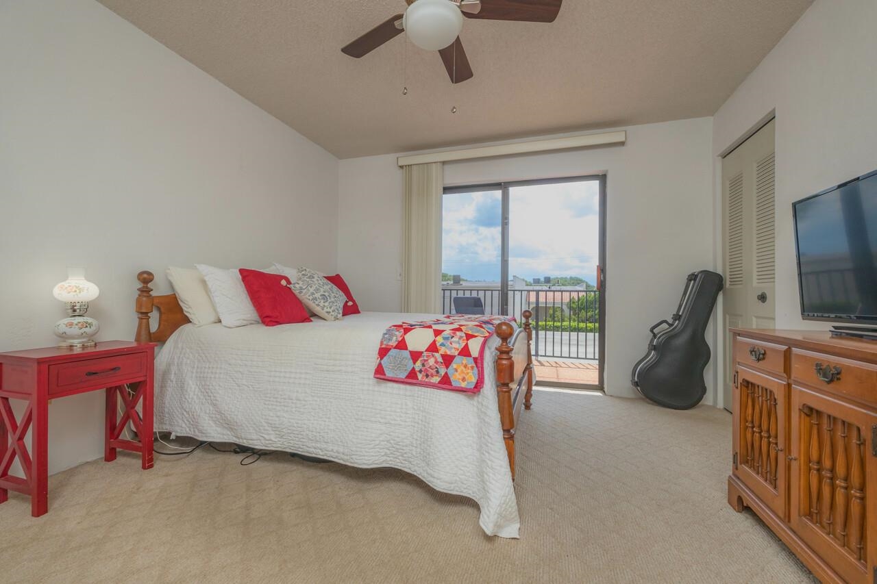 21 Dondanville Road, Unit 2 St. Augustine, FL 32080 - Photo 25 of 40 a bedroom with a bed and a flat tv screen