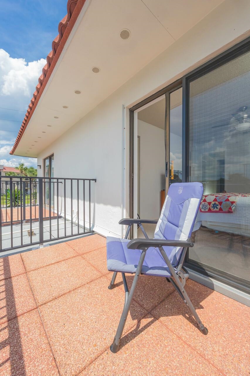21 Dondanville Road, Unit 2 St. Augustine, FL 32080 - Photo 26 of 40 a balcony with table and chairs