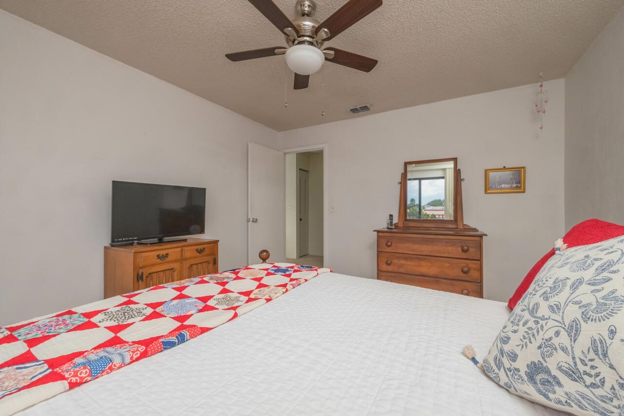 21 Dondanville Road, Unit 2 St. Augustine, FL 32080 - Photo 29 of 40 a bedroom with a bed and a flat screen tv