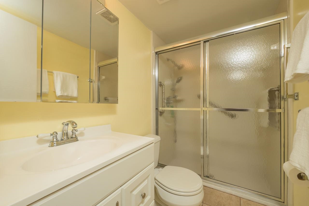 21 Dondanville Road, Unit 2 St. Augustine, FL 32080 - Photo 4 of 40 a bathroom with a sink vanity mirror and shower
