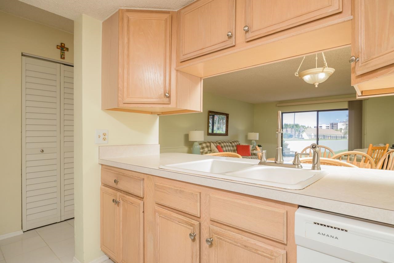 21 Dondanville Road, Unit 2 St. Augustine, FL 32080 - Photo 7 of 40 a room with kitchen island white cabinets and sink