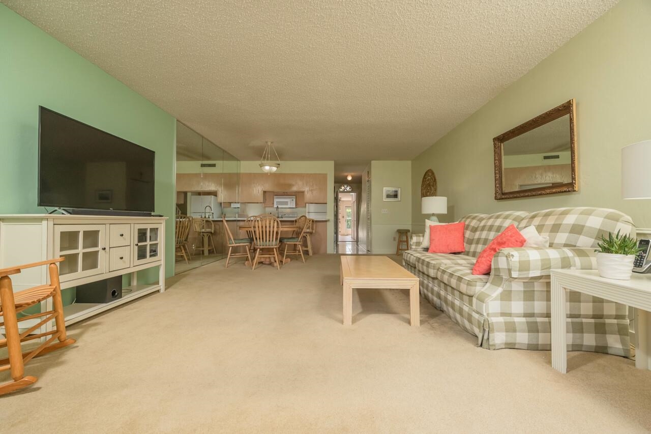 21 Dondanville Road, Unit 2 St. Augustine, FL 32080 - Photo 9 of 40 a living room with furniture and a flat screen tv