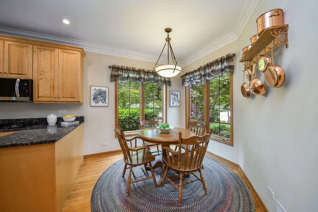 a dining room with furniture a chandelier and wooden floor