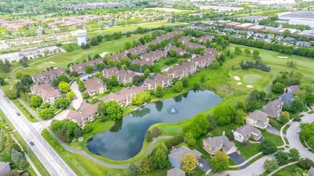 an aerial view of residential houses with outdoor space and street view