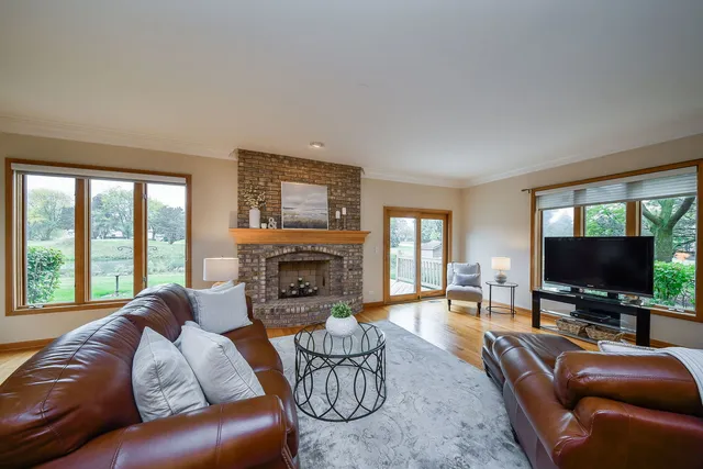 a living room with furniture a flat screen tv and a fireplace