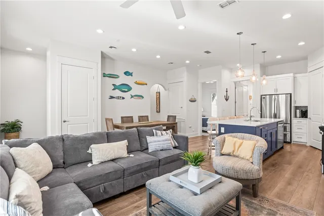 a living room with furniture and kitchen view